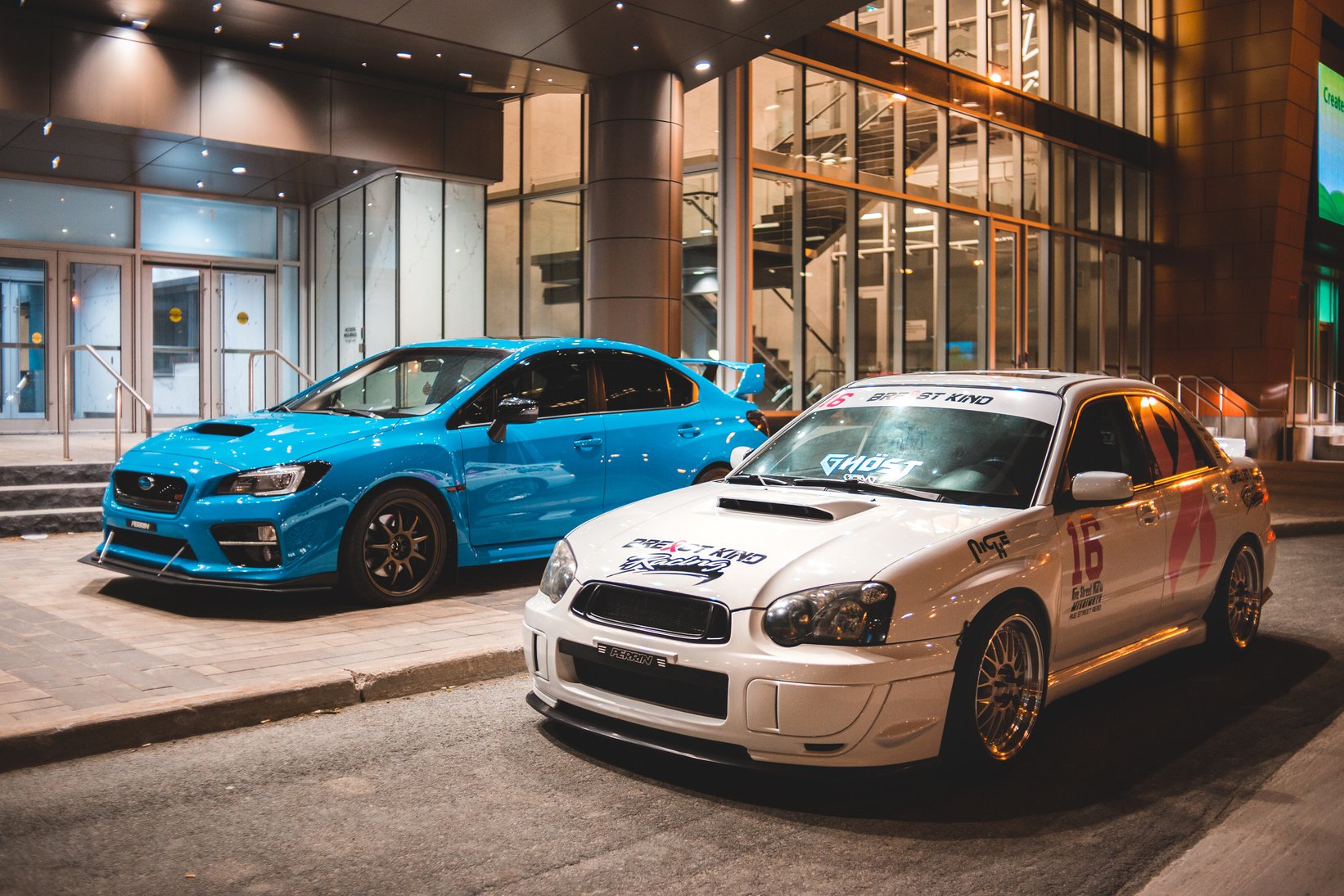 Sport cars parked near modern city building